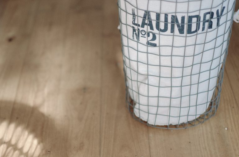 white laundry basket on wood floor