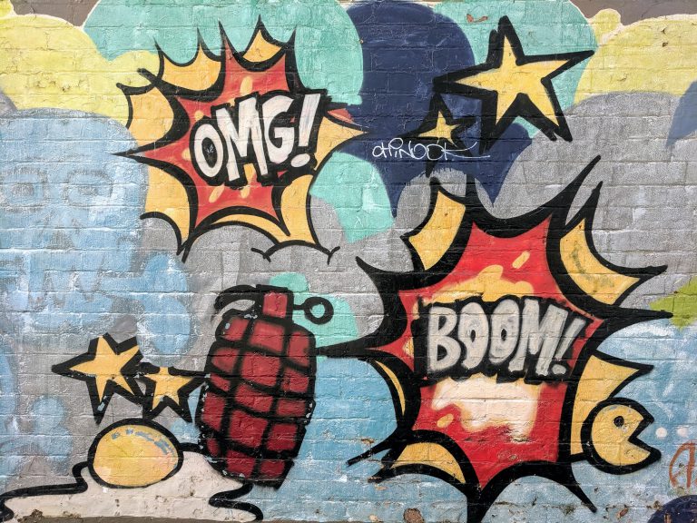 omg! and boom grafitti on wall