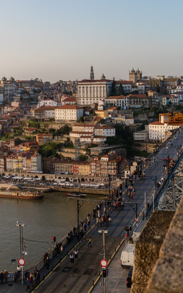 People walking on a bridge on the Duoro river in Porto