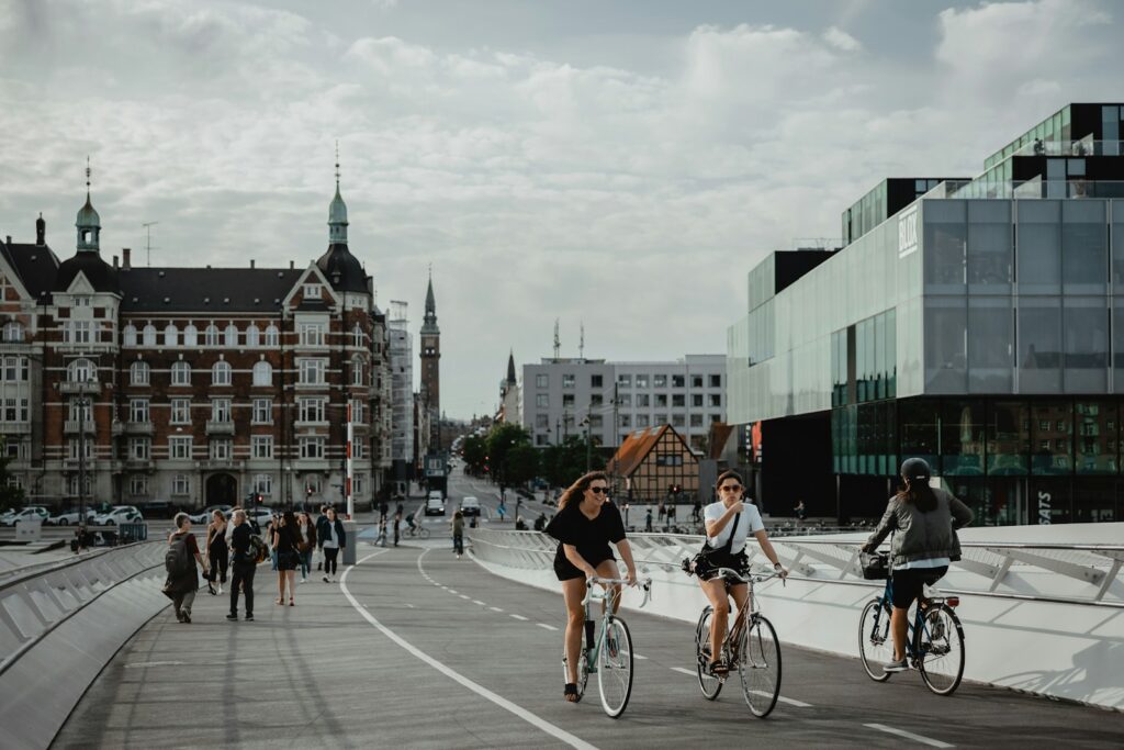 Cyclists commuting on a dedicated bike lane in Copenhagen, illustrating the city's bike-friendly infrastructure for those considering moving to Copenhagen.