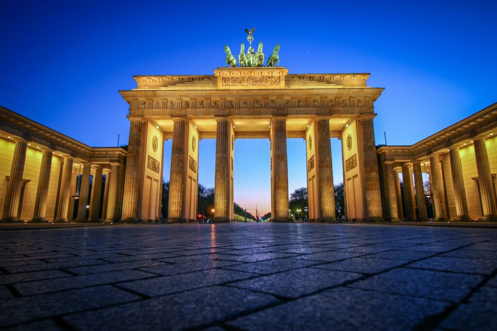 Iconic view of the Brandenburg Gate at dusk, symbolizing Berlin's rich history and cultural heritage, making it a landmark sight in Mitte, one of the best neighborhoods to visit in Berlin